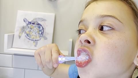 kid is using a toothbrush